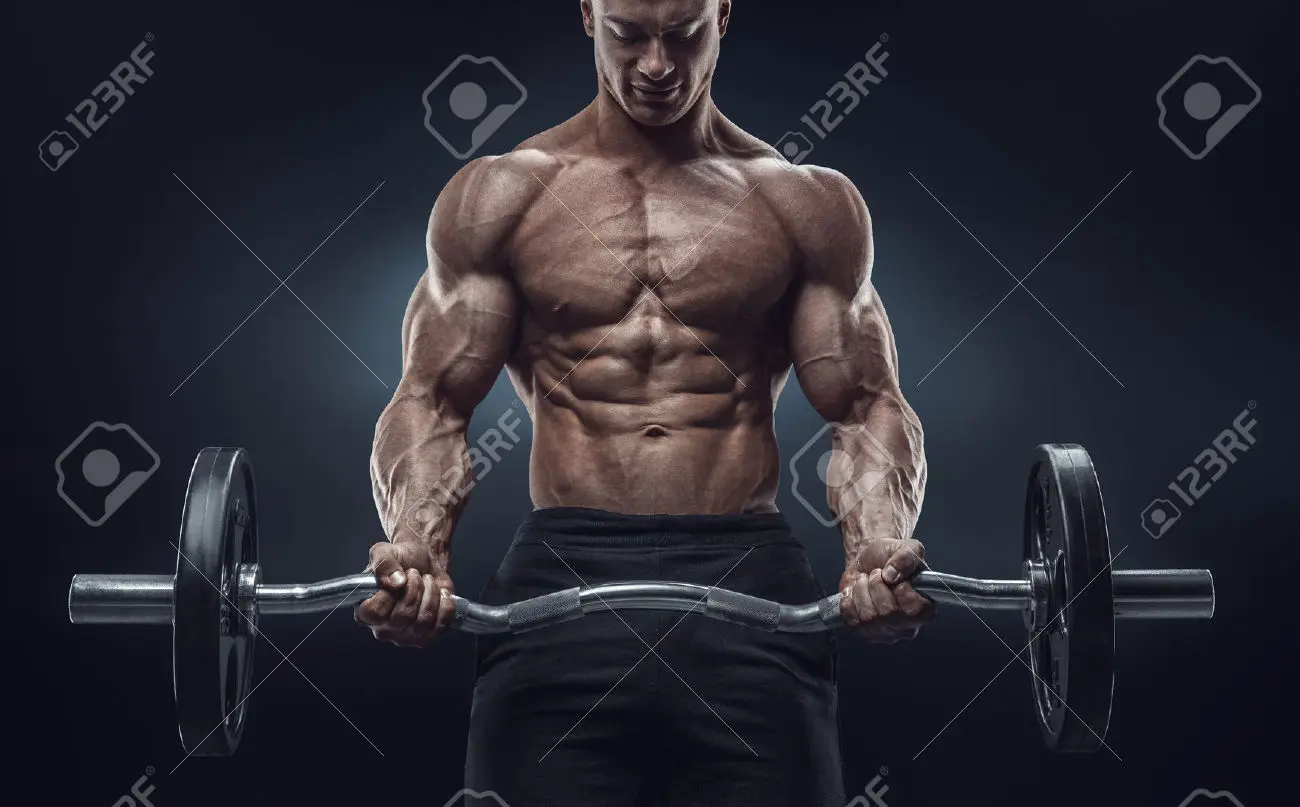 41423185 Closeup portrait of a muscular man workout with barbell at gym Brutal bodybuilder athletic man with Stock Photo