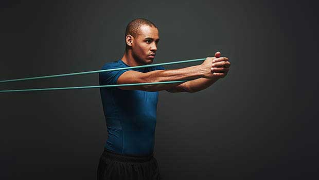 man using a resistance band carousel