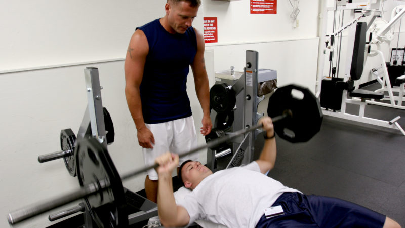 CAMP H.M. SMITH, Hawaii - Staff Sgt. Brett Garmon, G-4 air staff noncommissioned officer, U.S. Marine Corps Forces, Pacific, utilizes the bench press and weights, while safely being spotted by Master Sgt. Bill Atwater, G-4 maintenance management chief, MARFORPAC at the  Semper Fit Center here.