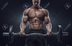 41423185-Closeup-portrait-of-a-muscular-man-workout-with-barbell-at-gym-Brutal-bodybuilder-athletic-man-with--Stock-Photo